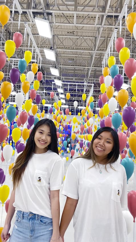Laura and Sarah, best friends at an experience pop-up in Toronto, Ontario